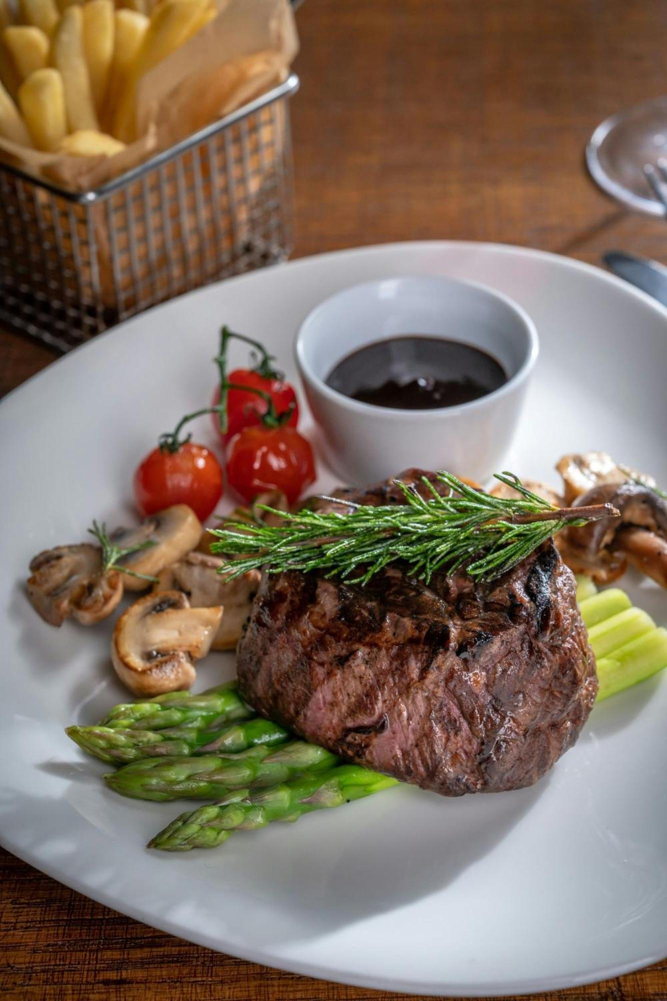 Marriott Hotel Al Jaddaf, Dubai Dış mekan fotoğraf A steak prepared with a sprig of tarragon